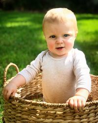 Portrait of cute baby girl in basket