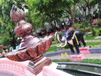 Statue of buddha against trees