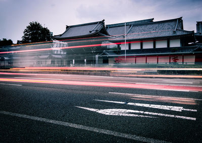 Light trails on street against buildings in city