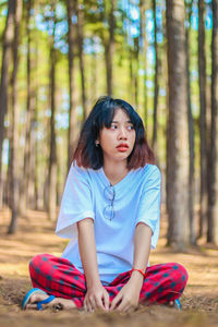 Full length of a girl sitting on land