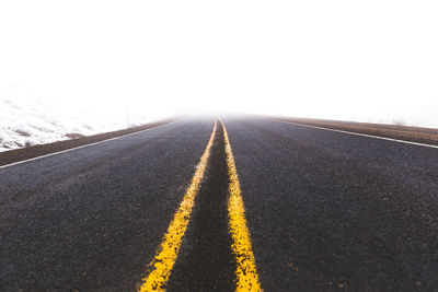 Empty road against clear sky