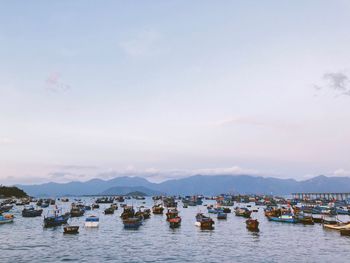 Boats moored in lake against sky