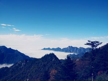 Scenic view of mountains against blue sky