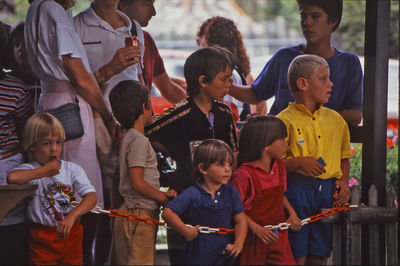 Rear view of people standing outdoors