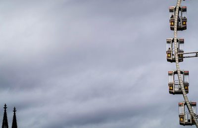 Low angle view of communications tower against sky