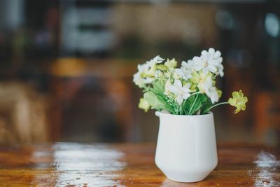 Close-up of white flower vase on table