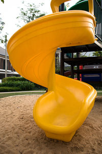 Close-up of yellow slide in playground