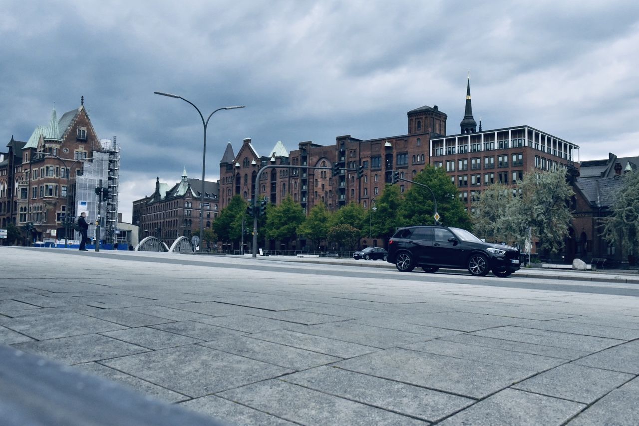 STREET BY BUILDINGS AGAINST SKY IN CITY