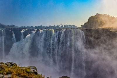 Panoramic view of waterfall against sky