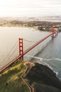 Golden gate bridge over river against sky