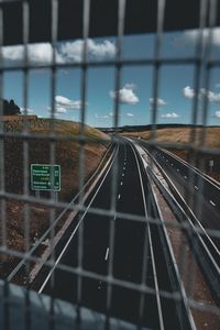Railroad tracks seen through glass