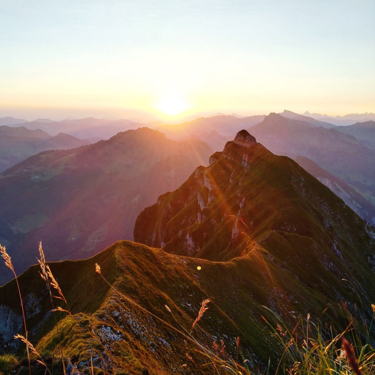 sky, mountain, scenics - nature, sunset, beauty in nature, environment, mountain range, tranquil scene, tranquility, non-urban scene, landscape, nature, no people, idyllic, sun, orange color, majestic, remote, outdoors, sunlight, mountain peak