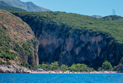 Scenic view of sea and mountains against sky