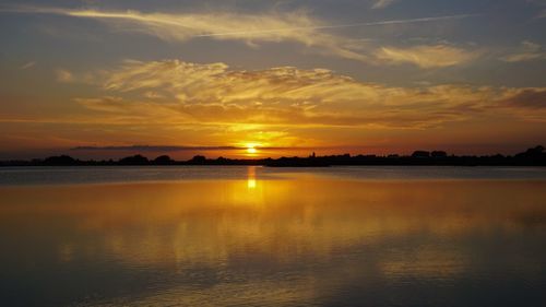 Scenic view of lake against sky during sunset