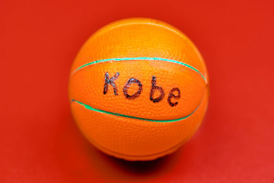 Close-up of orange ball against red background