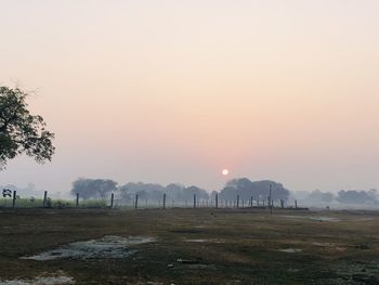 Scenic view of field against sky during sunset