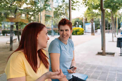 Young woman using mobile phone in city