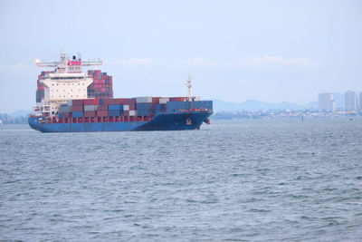 Ship sailing on sea against sky