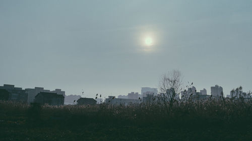 Buildings in city against clear sky