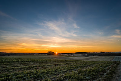 Scenic view of field against sky during sunset