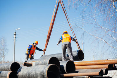 Low angle view of workers working at construction site