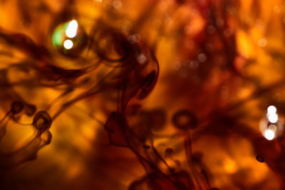 Full frame shot of water drops on illuminated orange