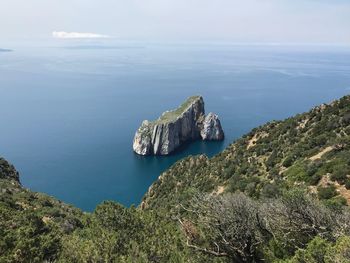 High angle view of rocks in sea against sky