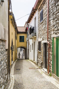 Narrow alley amidst buildings in city