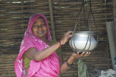 Portrait of woman wearing sari holding food hoder