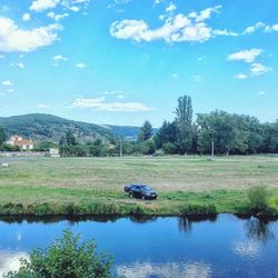 Scenic view of river against blue sky