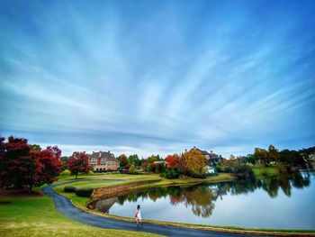 Scenic view of lake by trees against blue sky