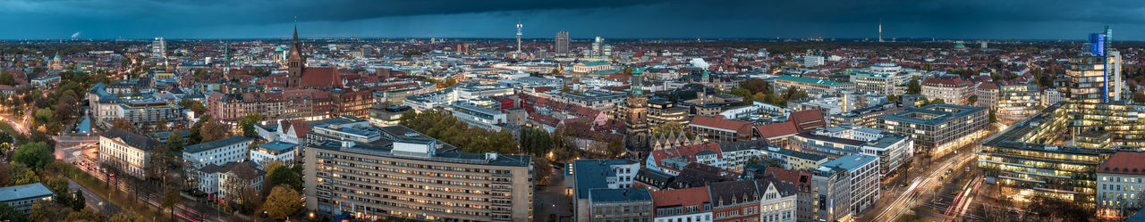 Panoramic view of illuminated city buildings