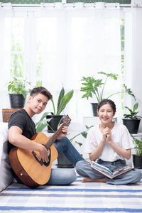 Young couple sitting outdoors