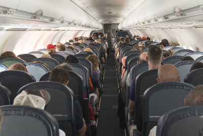 Rear view of people sitting in airplane