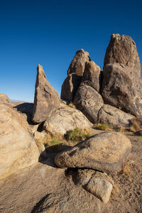 Rock formations against clear blue sky