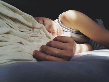 Close-up of woman sleeping on bed at home