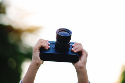 Cropped hand of woman using mobile phone