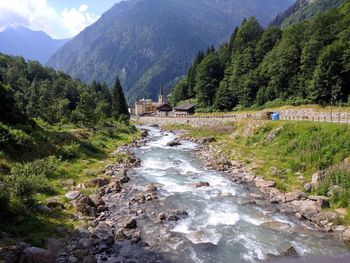 Scenic view of river amidst mountains against sky