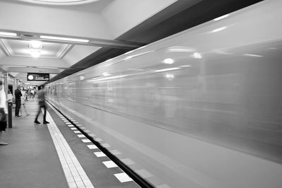 Train at railroad station platform at night