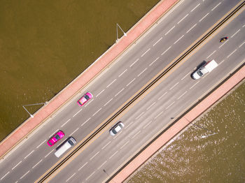 Aerial view of vehicles moving on bridge over sea