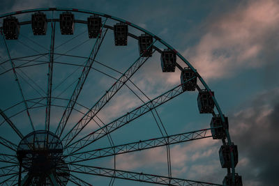 Low angle view of ferris wheel against sky