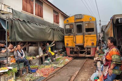 People at maeklong railway market