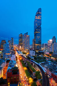 High angle view of illuminated cityscape against sky at night