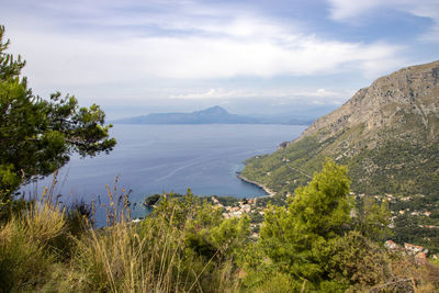 Scenic view of lake and mountains against sky