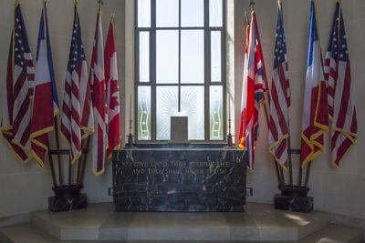 Multi colored flags on glass window