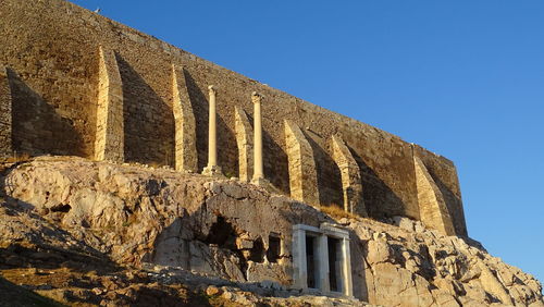 Low angle view of historical building against clear blue sky