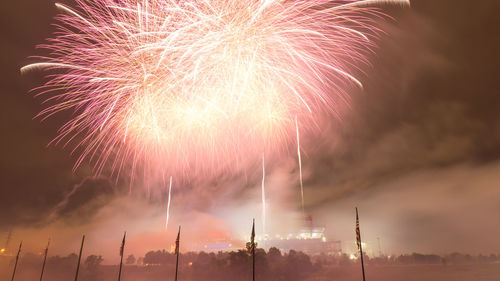 Low angle view of firework display at night