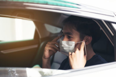 Young man wearing sterile medical mask coronavirus pandemic. social distance concept.