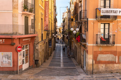 Narrow street amidst buildings in city