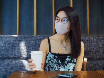 Young woman drinking coffee cup